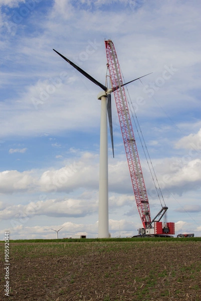 Obraz crane pulling blades off a wind turbine