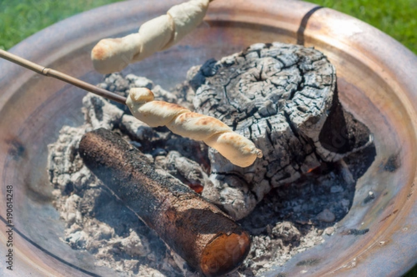 Fototapeta Bread baking over open fire - Snobrød