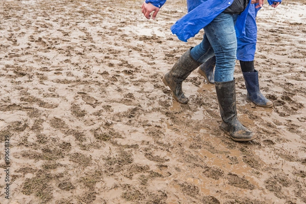 Obraz In rubber boots on dirt, at the festival
