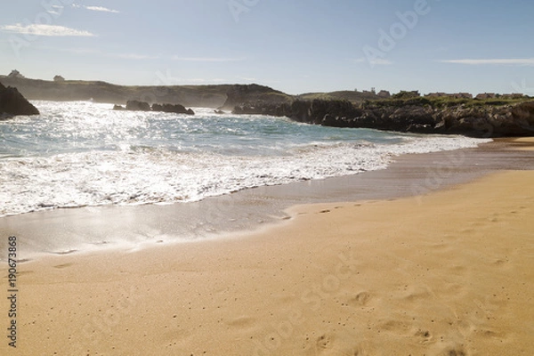 Fototapeta beautiful beach with waves breaking on the shore and without people
