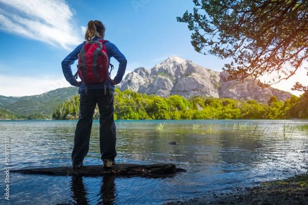 Fototapeta Woman hiker enjoys view of the lake and mountains. Bariloche, Argentina