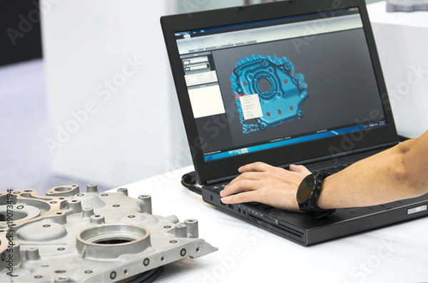 Fototapeta engineer working on computer at the design of mechanical piece