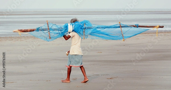 Obraz A fisherman going for his daily work