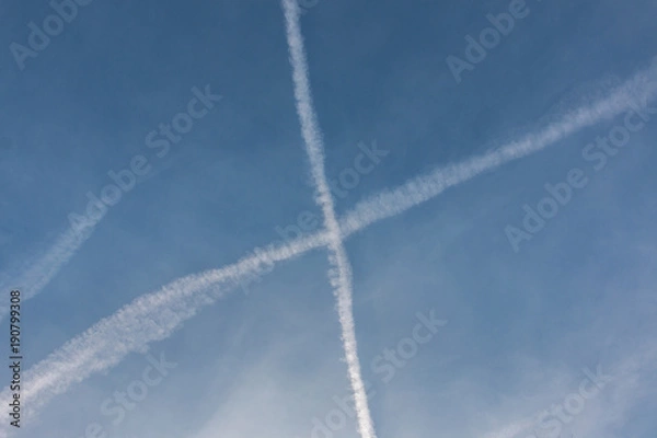 Fototapeta Contrails in the blue sky