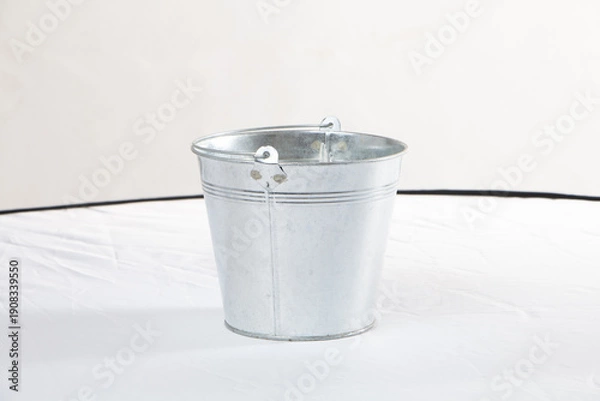 Obraz gray metal bucket on a white background
