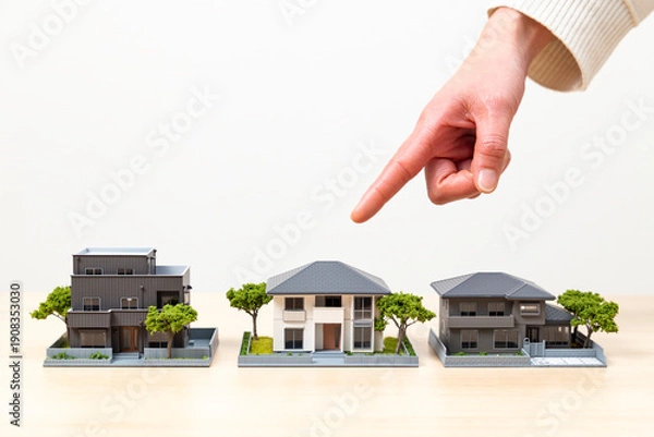 Fototapeta 住宅を選ぶ女性の手