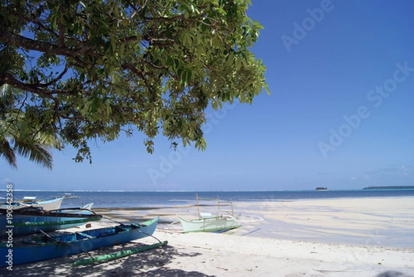 Fototapeta Seaside Scene with Outriggers by a White Beach