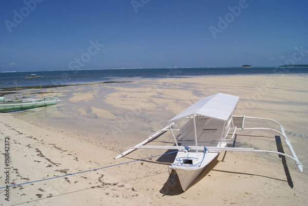 Fototapeta White Outrigger Moored on White Beach