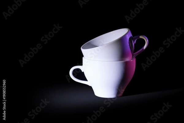 Obraz Two white coffee cups on black with violet backlight source