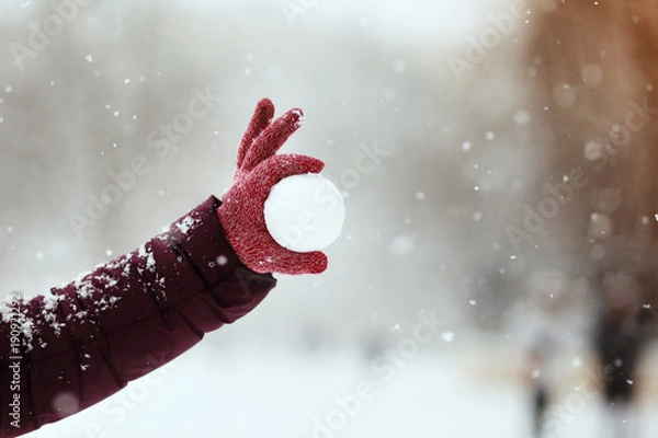 Fototapeta Close up of woman holding the snowball in hands, winter concept with copy space