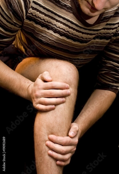 Obraz Young man having knee ache