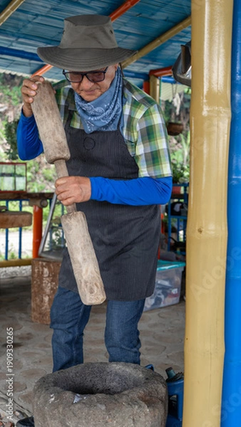 Obraz A farm man shoveling corn
