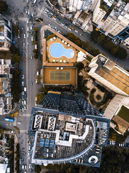 Fototapeta Drone view of building with pool and tennis court