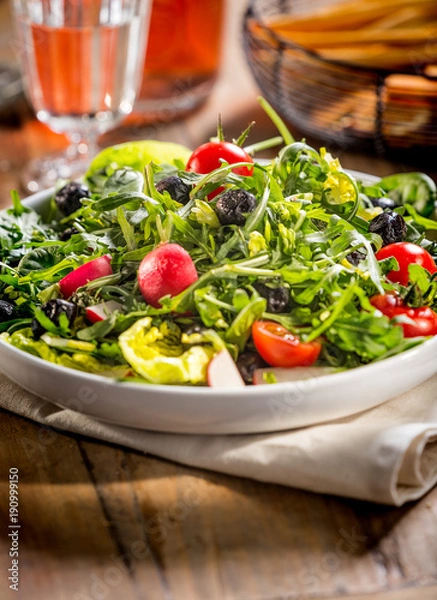 Obraz Green salad served on the plate.