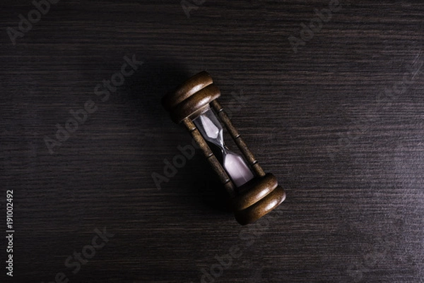 Fototapeta Hourglass on table background.
