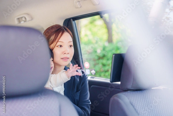 Obraz 子供と一緒にタクシーに乗る忙しいお母さん