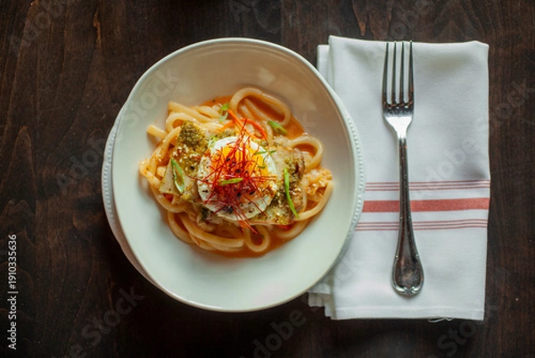 Obraz Looking down on noodle dish with egg on top