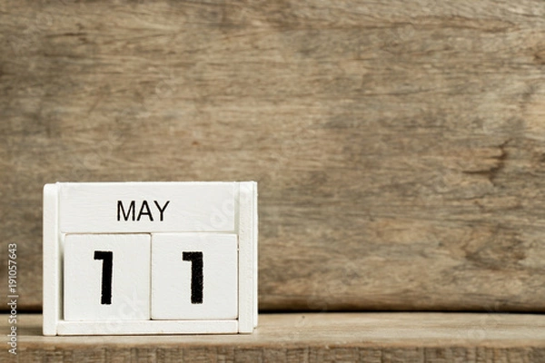Fototapeta White block calendar present date 11 and month May on wood background