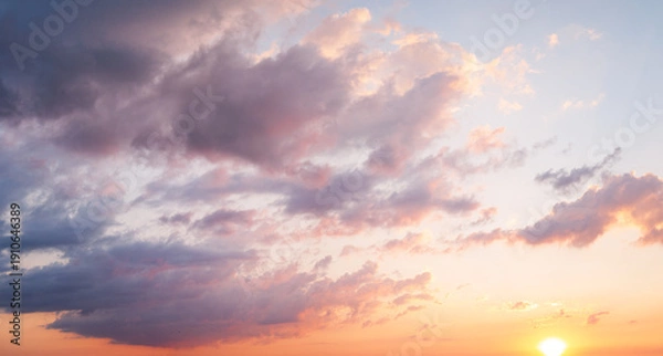 Fototapeta Dramatic clouds with sun rays breaking through sunset sky