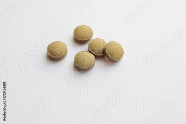 Obraz Round herbal tablets on white background