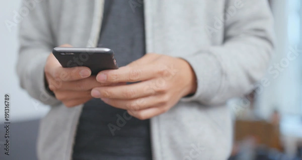 Fototapeta Man use of cellphone