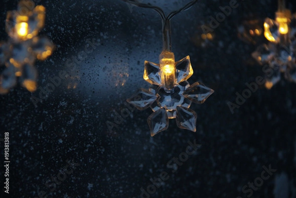 Obraz decorative snowflake light string on frosty window