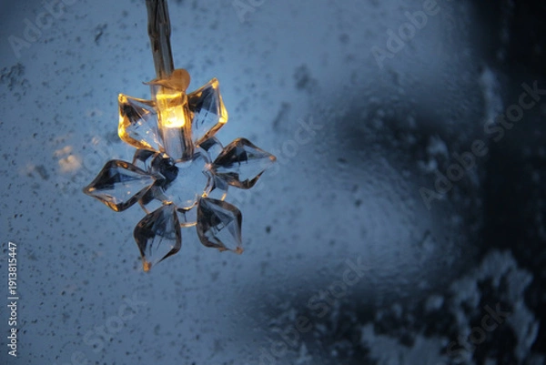 Obraz decorative snowflake light string on frosty window