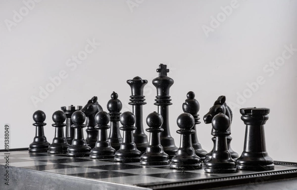 Fototapeta Black chess side view on a black background