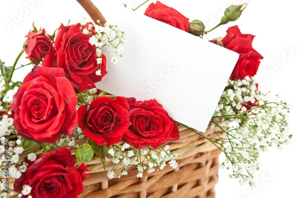 Fototapeta Red roses and blank card in wicker basket