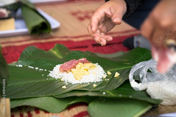 Obraz Making Chung cake by hands closeup, Chung cake is the most important traditional Vietnamese lunar New Year (Tet) food.