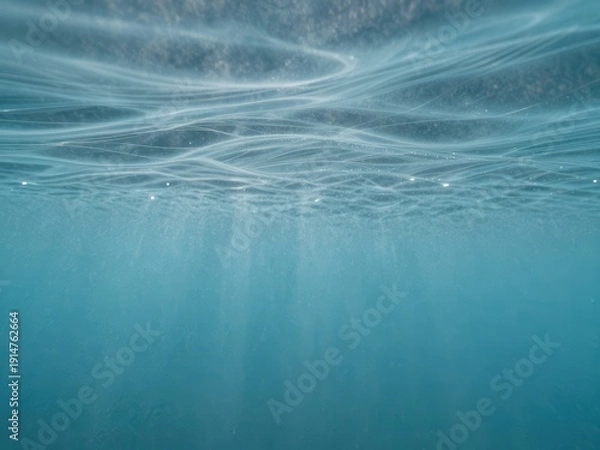 Obraz Cerulean underwater light rays with gentle waves surface