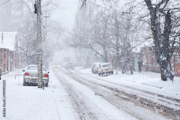 Fototapeta Snowfall in the street in the city fell asleep and almost nothing is visible from behind the snow