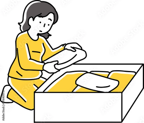 Obraz 箱に衣類を入れている女性