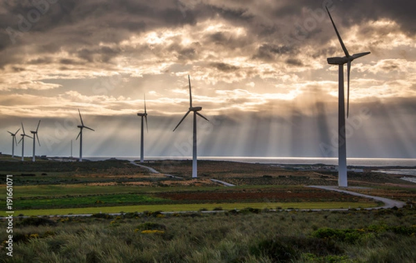 Obraz The Wind turbine stand with amazing nature of the sun ray and cloudy. In Tunisia has nature energy and there is the one of landmark in Tunisia,  Alternative and clean energy concept.