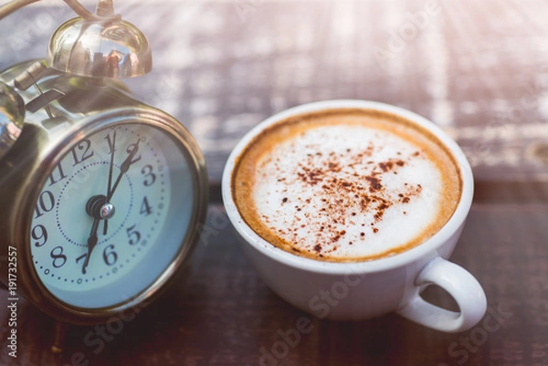 Fototapeta Coffee cappuccino in the morning and an alarm clock