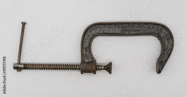 Obraz Vintage adjustable  clamp for carpenter work in an old traditional style wood working workshop