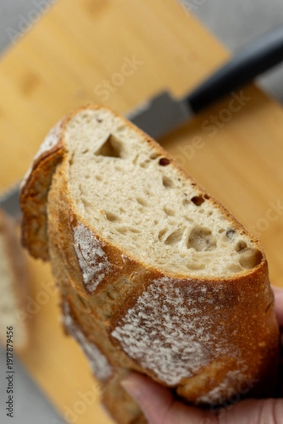Obraz Hand holding artisan rustic bread loaf