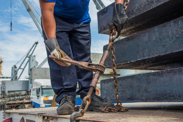 Fototapeta lashing gang works on the safety securing the cargo on the trailer before transport, cargo aand shipment transfer from the ship in port delivery to destination by logistics services