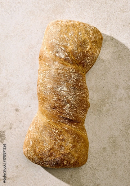Obraz Rustic artisan bread loaf on light background, top view