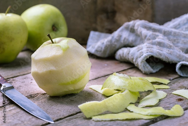 Obraz Green peeled apple on natural rustic wooden background.