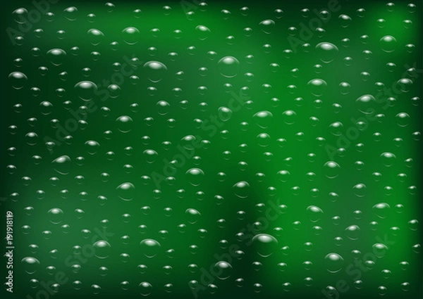 Fototapeta Drops of rain on an evening summer day on a glass of trees blurred green background.