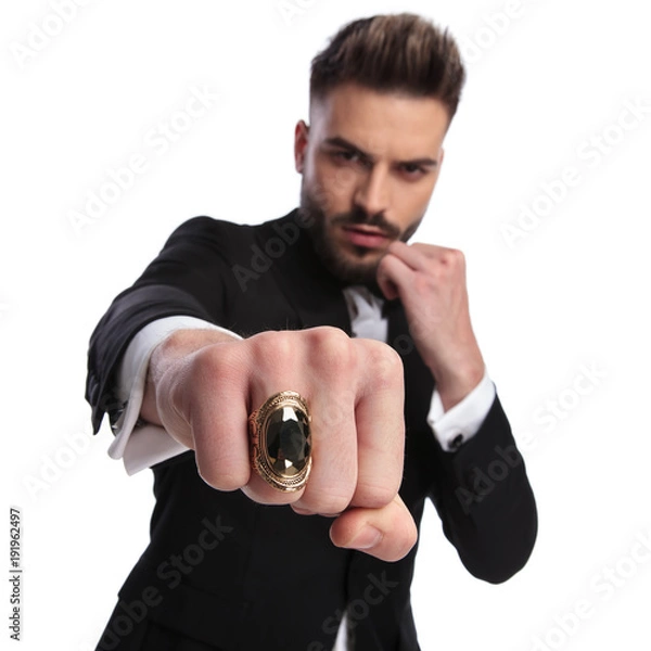 Fototapeta elegant man in fight position is throwing a punch