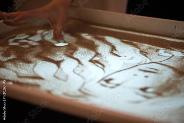 Obraz Hand Drawing Portrait Shape In Illuminated Sand Surface