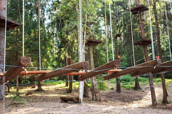 Fototapeta Elements of a rope town. Attributes for active family rest. Sports entertainment in nature.