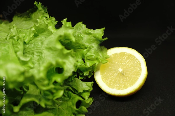 Fototapeta lettuce and lemon on black background