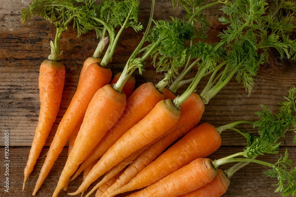 Fototapeta 新鮮な葉付きにんじん(木目背景)