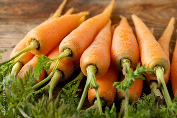 Fototapeta 新鮮な葉付きにんじん(木目背景)
