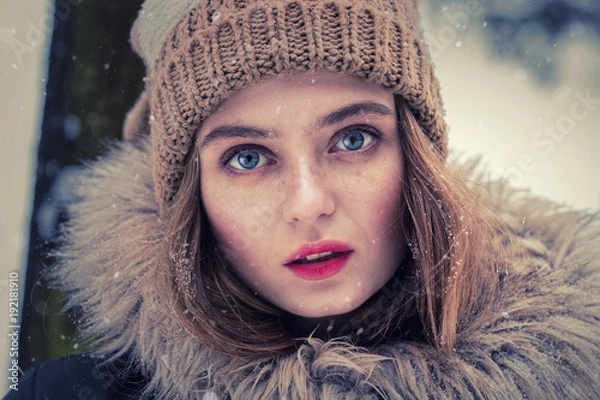 Fototapeta Portrait of a beautiful girl dressed for winter. Beautiful features, nice face