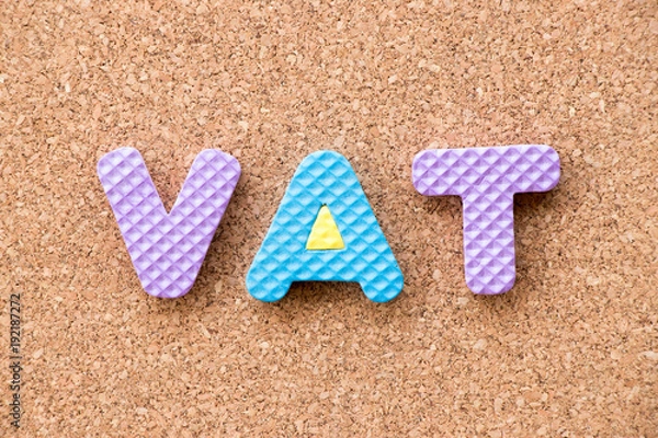 Fototapeta Color toy foam alphabet in word VAT (Abberviation of Value added tax) on cork board background