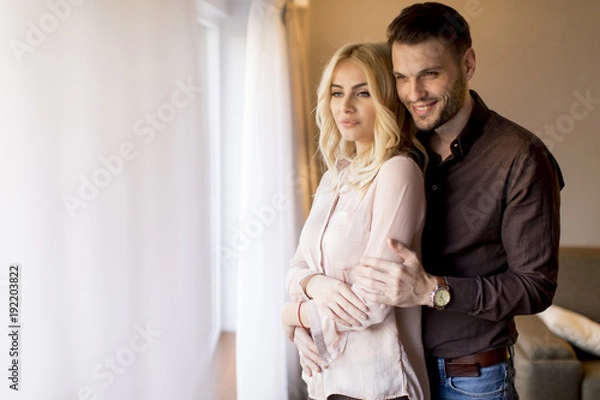 Fototapeta Loving couple by window in the room